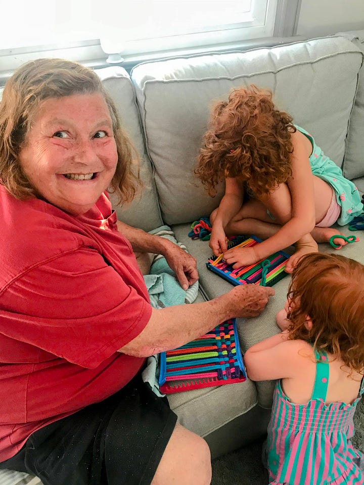 Grandma teaching kids how to weave potholders