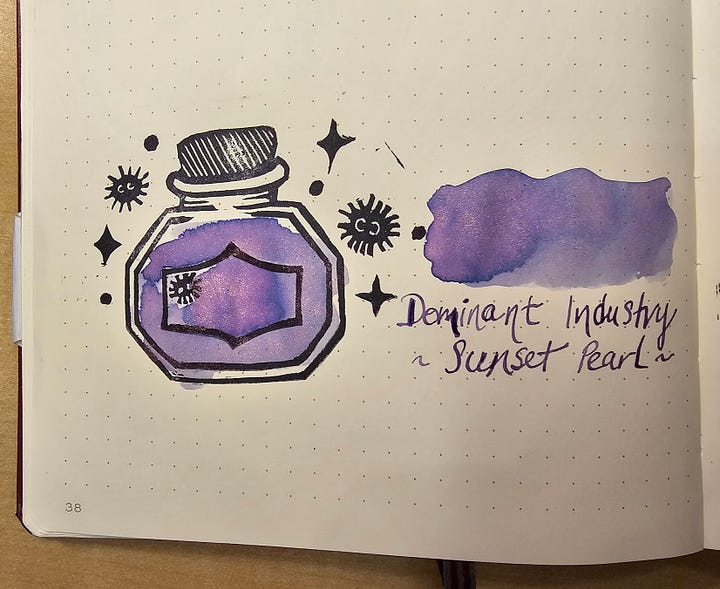Four photos of a custom made stamp featuring an ink bottle, soot sprites, and sparkles. 