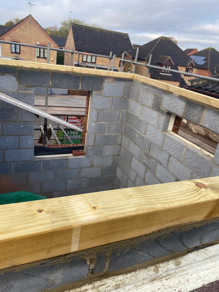 full height of brickwork and wooden pillars added around the edge of the brickwork