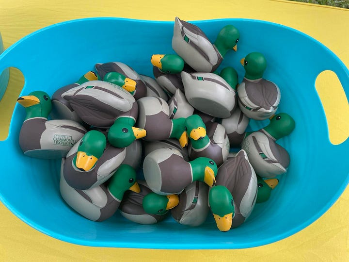 A bowl of rubber ducks and some individually wrapped cookies shaped like ducks