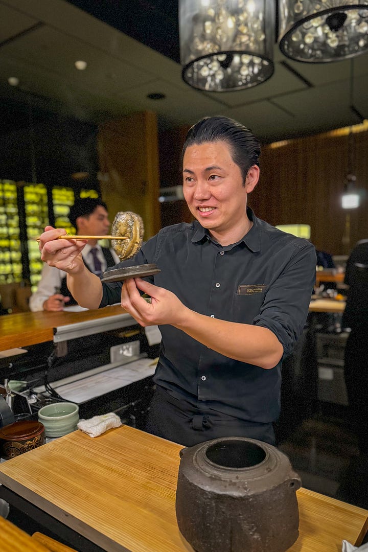 Chef Taka showing off his long-developed steamed abalone in liver sauce