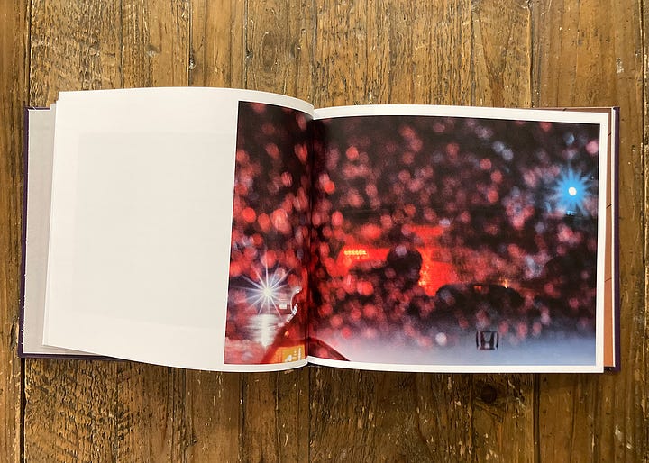 A purple draft cover of the photobook, Visibility, is shown. Three 2-page spreads showing atmospheric photographs taken in all weather conditions are shown. The photos include artistic images of a lake, the driver of a car sitting in traffic during a rainstorm, and a rainy night in Minneapolis with skyscrapers reaching into the foggy haze. 