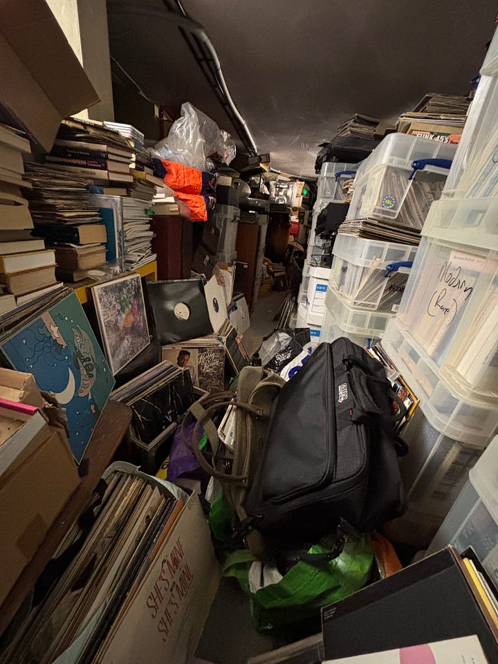 The basement is floor to ceiling records and books that have yet to make their way upstairs