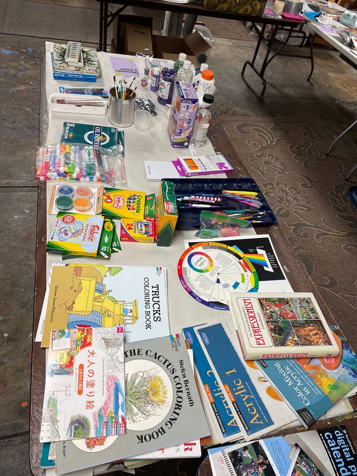 Swap tubs in a retail store, empty tables arranged in a basement, the same tables beginning to fill with materials, and a wide range of donated supplies on those tables from paint to frames.