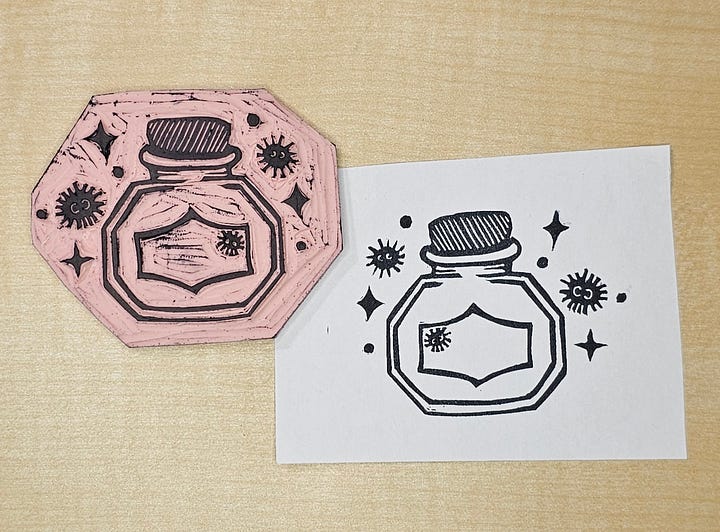 Four photos of a custom made stamp featuring an ink bottle, soot sprites, and sparkles. 