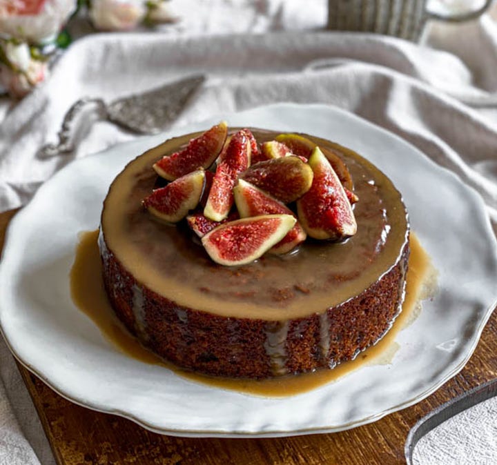 two sticky date puddings decorated with fresh figs