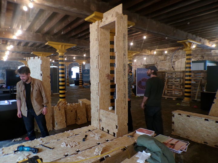 WIkiHouse parts being assembled into a small structure