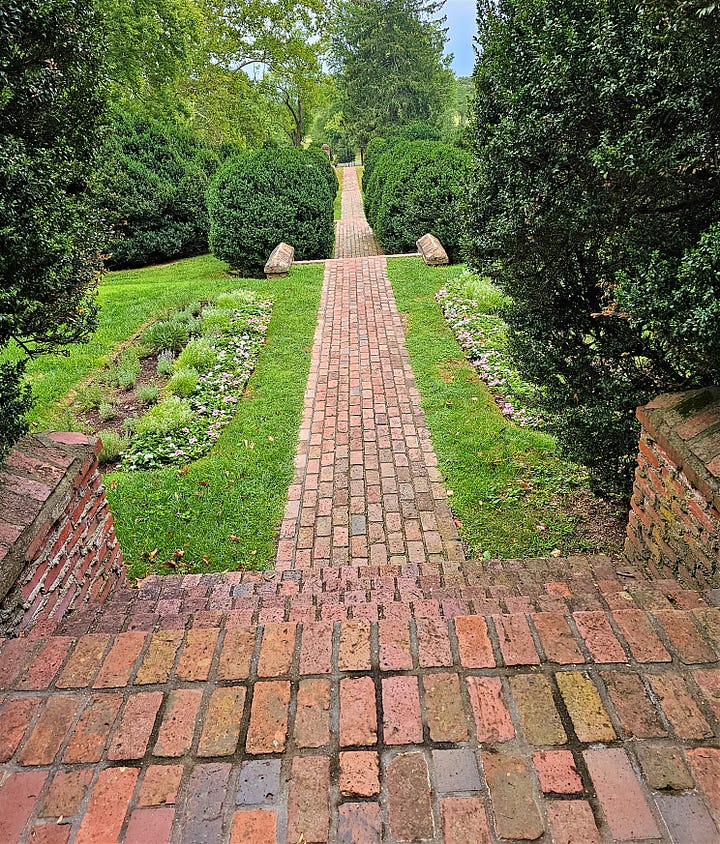 The reflecting pool, garden area, and brick sidewalks in Morven Park gardens.