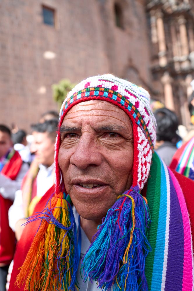 Four portraits taken during the Corpus Christi procession. The portraits show the diverse costumes of the procession attendees including two brightly colored rainbow outfits. 