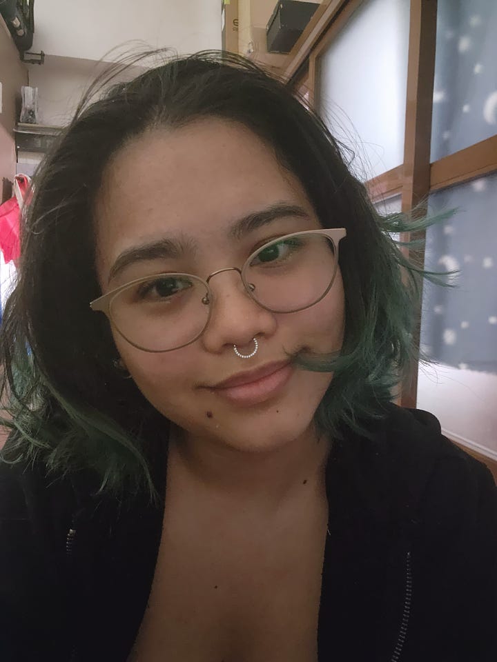 Two selfies of myself wearing eyeglasses with my septum piercing