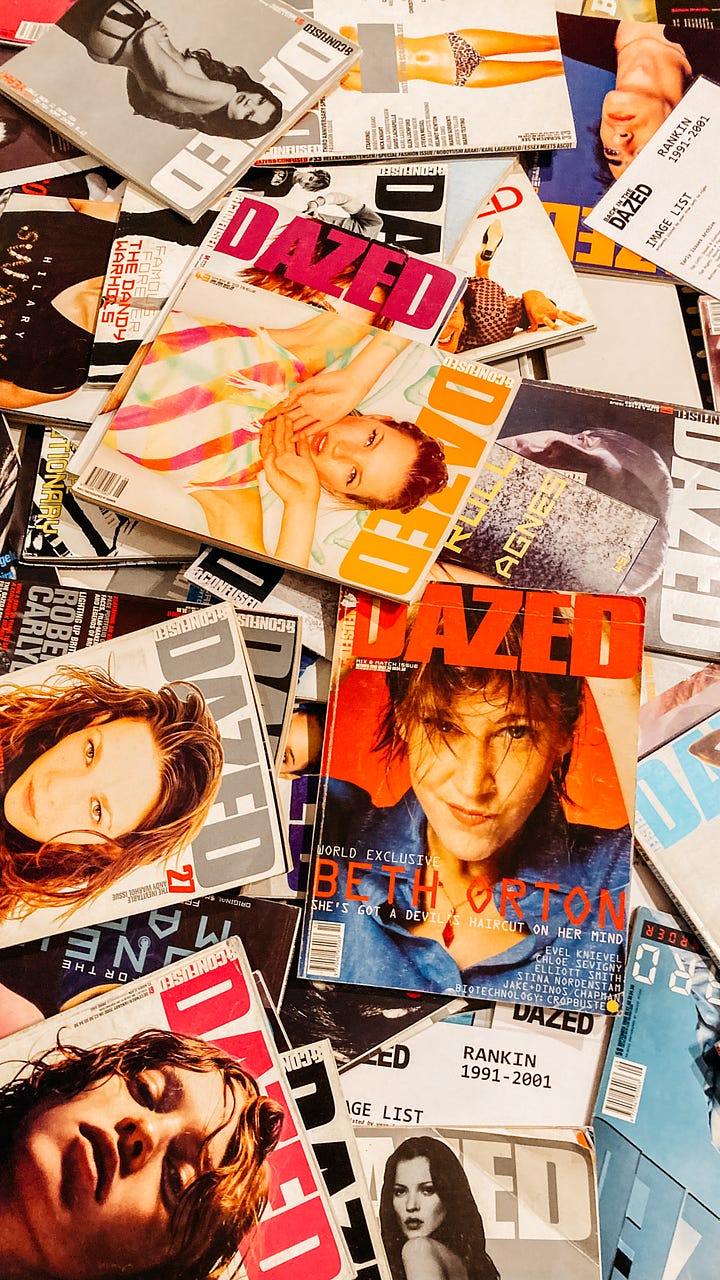 a messy stack of magazine covers featuring the photos of Rankin; elvis costello and chloe sevigny