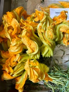 green peppers, red cherries, peaches, apricots, squash blossoms, strawberries at the market in Como, Italy