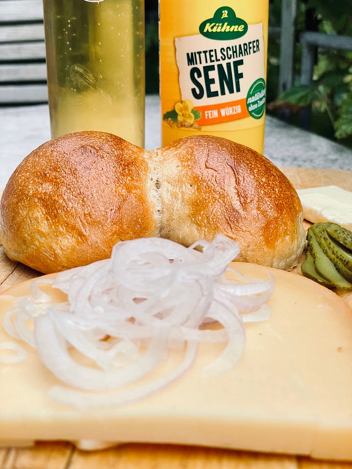 Colonge Rye Rolls and same rolls but as the Cologne Variant of a Halve Hahn with Gouda, Gerkins, Onion and Butter