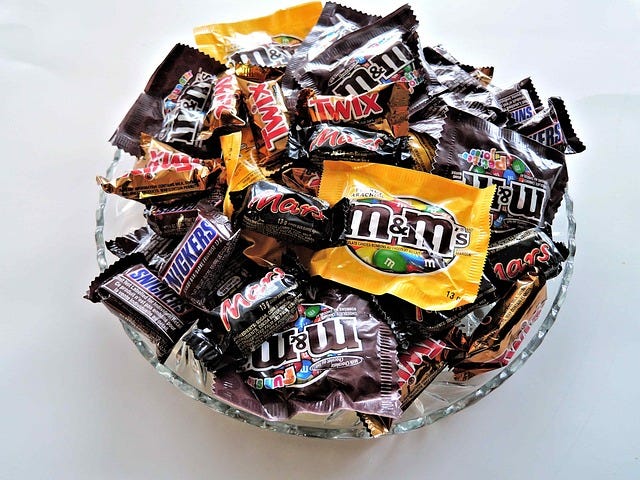 Bowl of assorted Halloween candy; bowl of candy corn