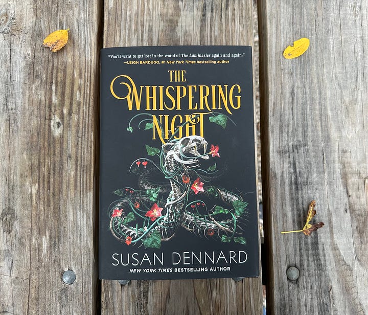 Images of the US edition of The Whispering Night, one showing Susan holding it and smiling. A mother showing it lying on a wooden background. Another showing the hardcover stamp of the Luminaries moon in copper. And a final image of the Whispering Night with beach grass and a green wall behind it.