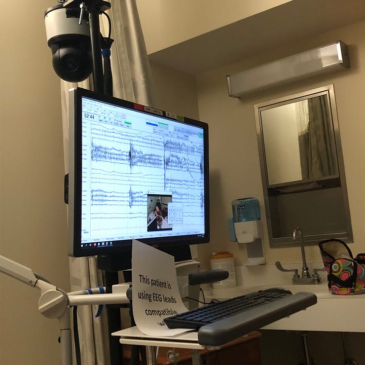 Sample gallery of the EEG stand, topped with rounded black video camera, computer screen with row after row of squiggly lines, the rectangular hanging strobe light, and the rainbow hued collection of wires inside its blue felt carry-pouch.