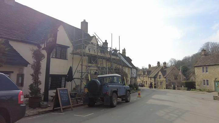 The two pubs in Castle Combe. The Castle Inn and The White Hart which has scaffolding currently in place. Both pubs are built of stone and render and are both very old. Images: Roland's Travels