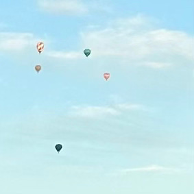 Hot air balloons fly in the sky in Canberra, Australia