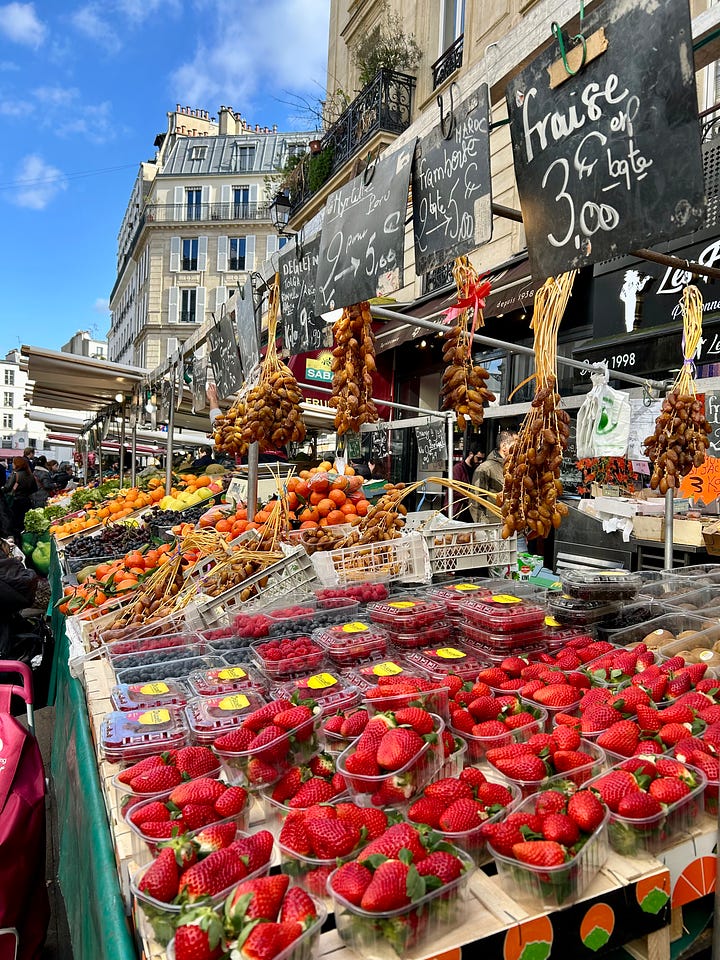 French food market with fruits, berries and fresh bread and baguette