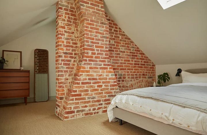 Original exposed red brick work in the living areas of both the living room and bedroom