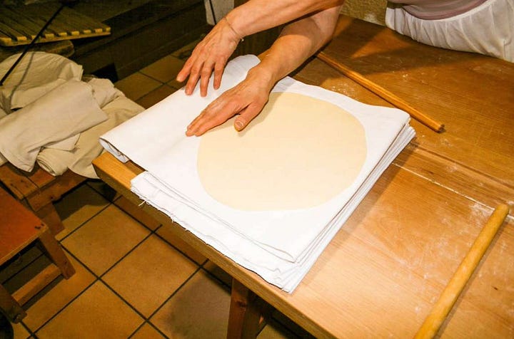 rolling out dough for pane carasau