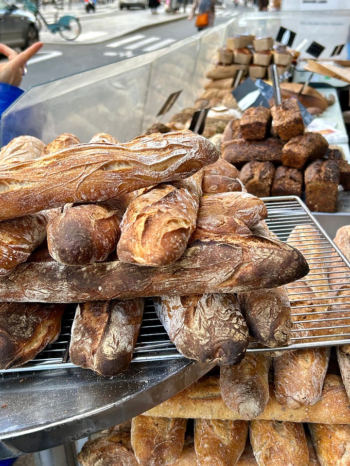 French food market with fruits, berries and fresh bread and baguette