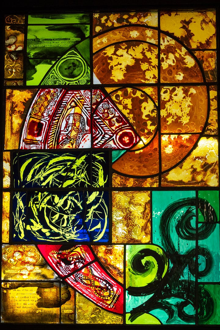 Dunbeath Heritage Museum sign and a stained glass window suggestive of river life and Pictish symbols © Felicity Martin