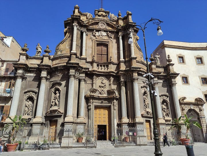 A large weather vane the size of a car and ornate buildings from Palermo