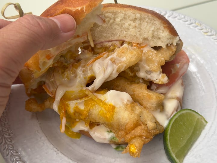 Fried lenguado smothered with aji and mayo in between brioche buns.