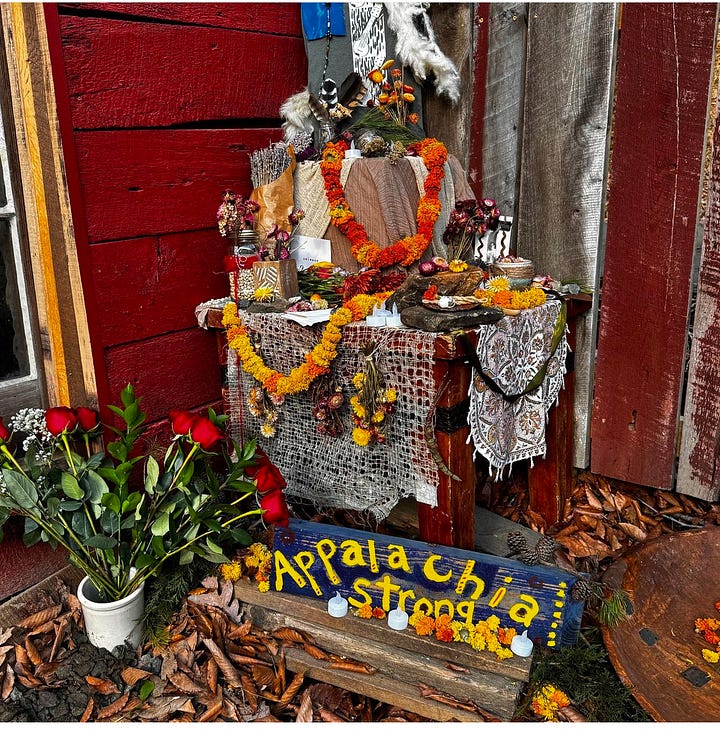 A photo of a grief altar set in the corner near the barn with the words 'appalachia strong' written on a piece of wood, flowers and candles and notes surround it. The 2nd photo is the silouhette of the barn against a blazing orange and red sunset. 