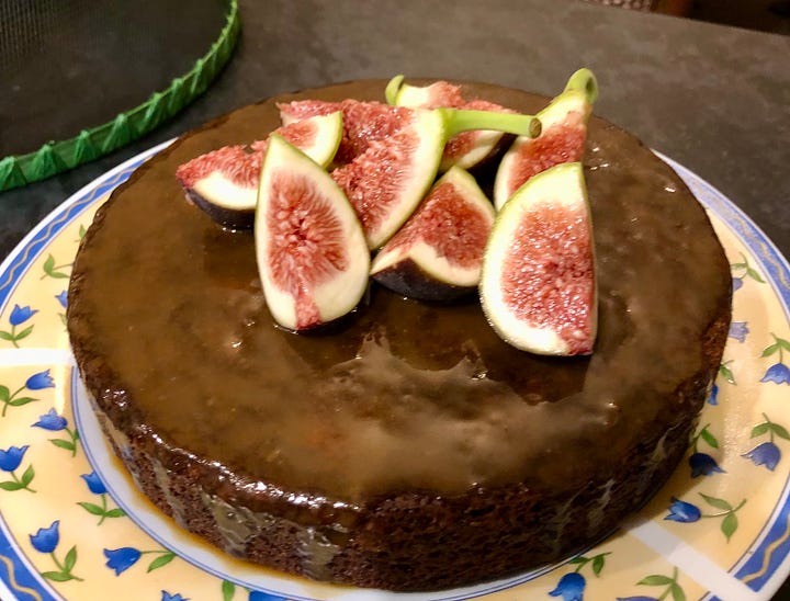 two sticky date puddings decorated with fresh figs