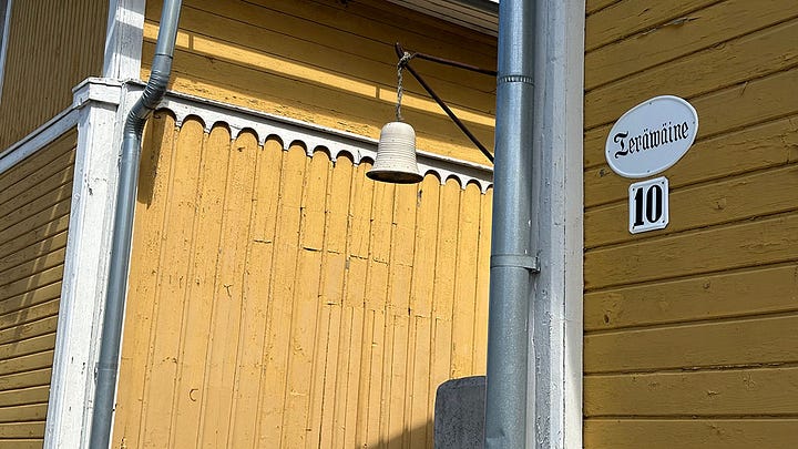 Details from Finland: 1. Moomin Shop window display of characters, 2. Nautical signal flags in Turku, 3. Carpentry details of a wooden house in Old Rauma, 4. Old photo of people dressed in masquerade from Naantali Museum