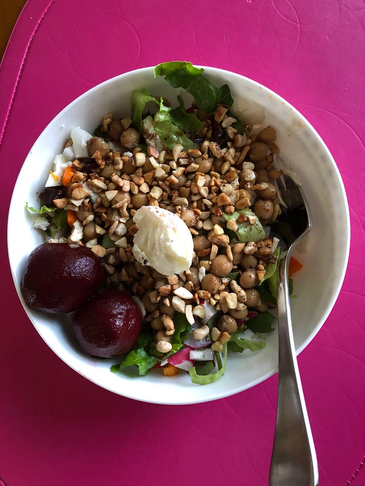 two colourful salads with nuts on top