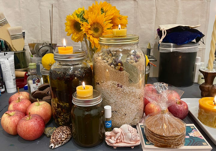 Images of a lush altar, set up on an art desk, dedicated to Juno-Ninsiana for the wealth, prosperity, and financial success of the participants.