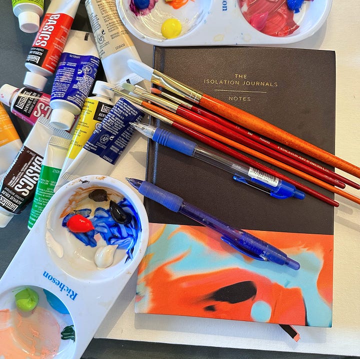 On the left is a photo of the Isolation Journal No. 1 along with pens, paint brushes, a palette, and various tubes of paint; so colorful! On the rihgt is a photograph of a small spotted dog with one brown eye and one blue eye, seated on a char beside the Surrender tote. 