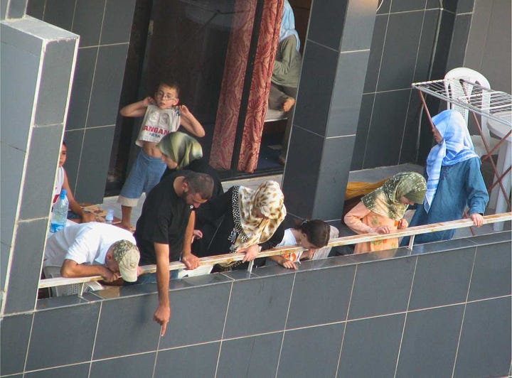 View from roof of Mayflower Hotel in Beirut of leaflets falling in Hamra during 2006 Lebanon War depicting Hezbollah building a castle of sand