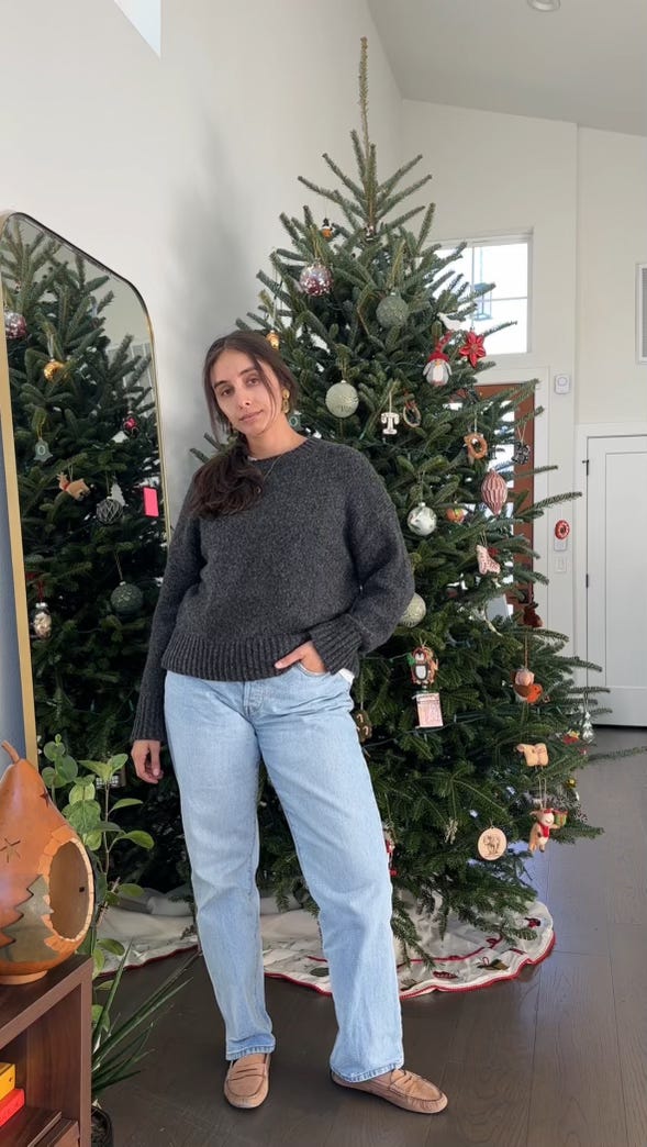 women standing in front of christmas tree