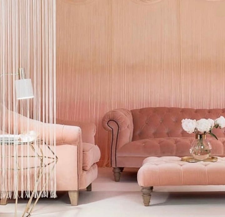 Two seating areas using varying tones of peach, from peach walls to peach furniture