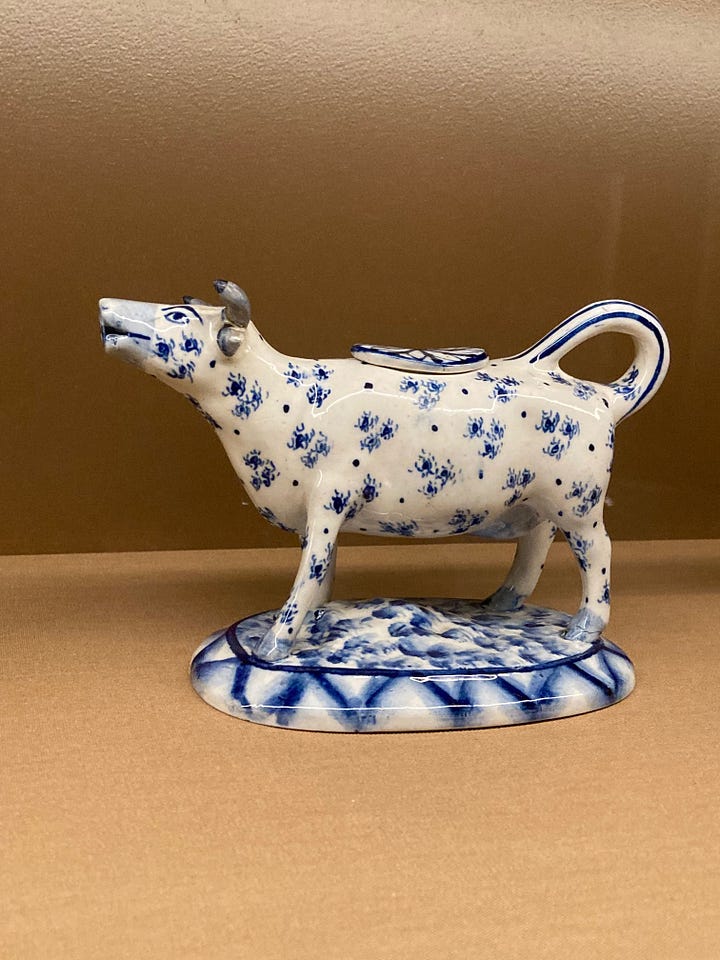 Four images of ceramic cow creamers, made late 18th centruy to early 19th century, and image of shelves holding several jugs 