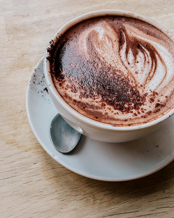 Image 1: Close-up of seasonal spiced hot chocolate from Söderberg. / Image 2: A bowl of porridge made with mashed banana and cacao.