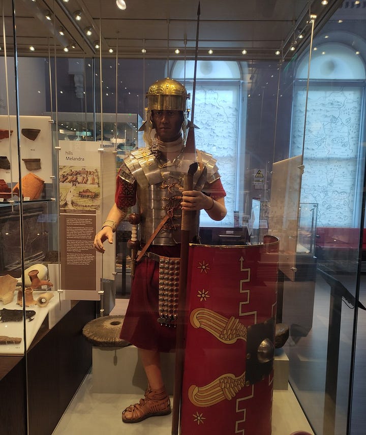 A stuffed bear, Roman legionary, display room and painting from the museum