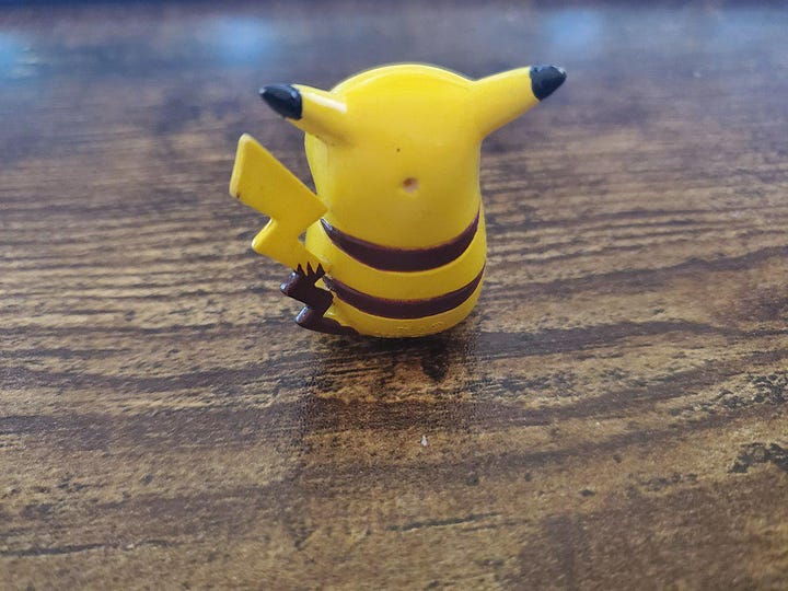 A selection of photographs from Shayne Roberts of his Pikachu Pencil Topper, and framed shirt