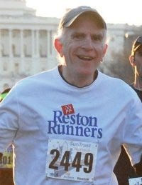 A man with a Reston Runners short on finishing a marathon, and a man in a navy uniform standing next to his mother