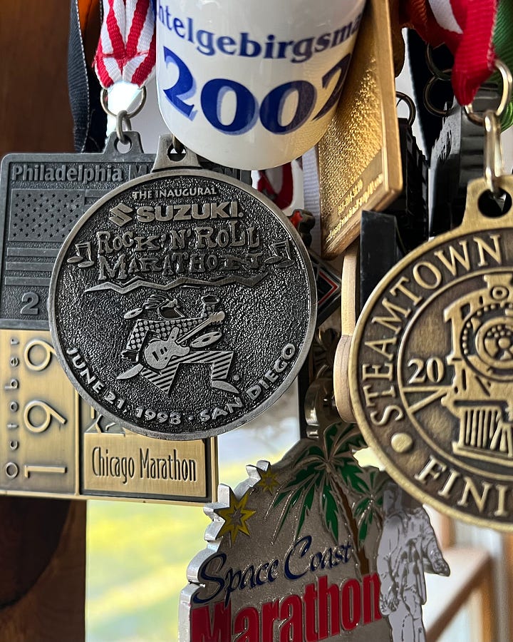 Renee, Lucas, and I after the race; my finisher's medal (hanging with other medals)