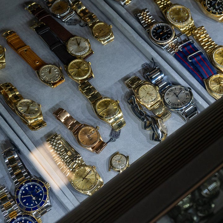 Pile of vintage gold Rolex and Cartier watches 