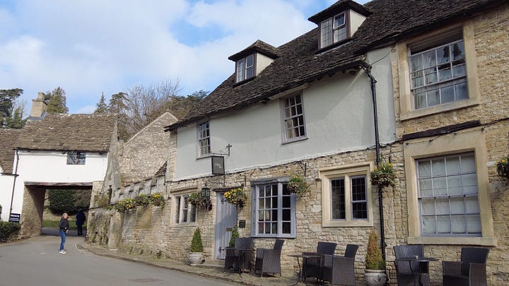 The two pubs in Castle Combe. The Castle Inn and The White Hart which has scaffolding currently in place. Both pubs are built of stone and render and are both very old. Images: Roland's Travels