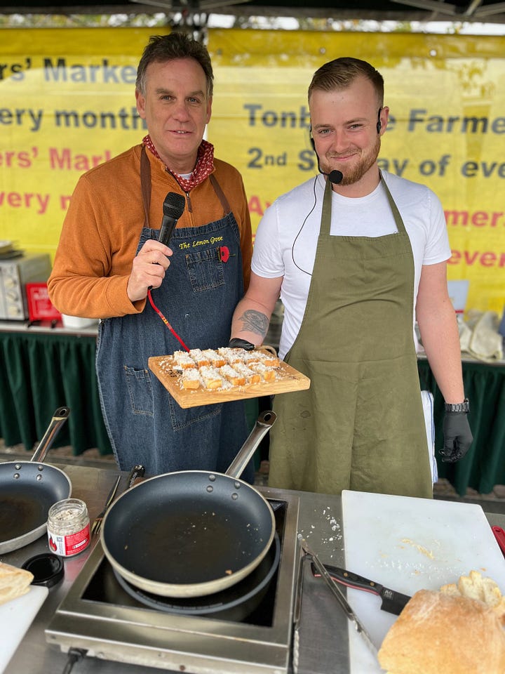 Chef Ben from Tonbridge cooking on stage with The Lemon Grove's Bruce McMichael