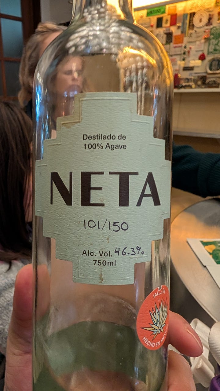 A bottle of Neta mezcal. Barrels of Tequila being aged - photo Fred Crandon via Unsplash.