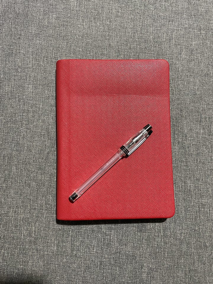 Photos of Jam's red journal (text blurred)