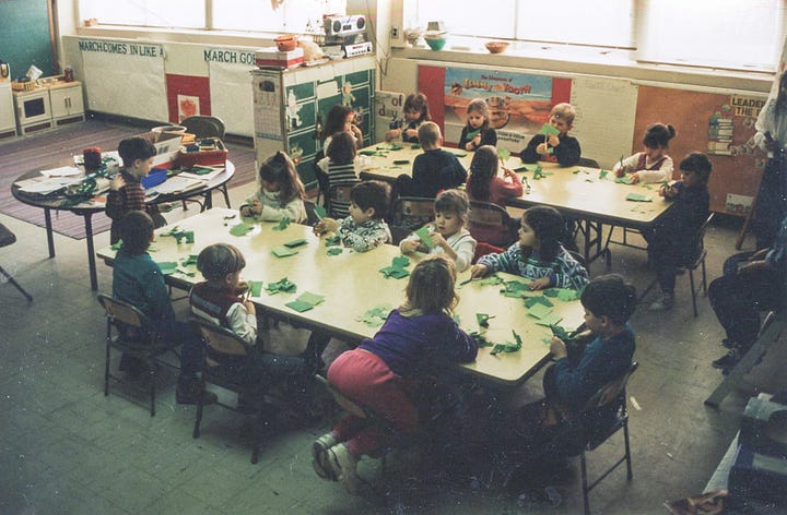 Children making paper shamrocks for St. Pat's Day